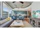 Open-concept living room featuring a contemporary kitchen, a comfortable sofa, and a large window for natural light at 777 N Ashley Dr # 915, Tampa, FL 33602