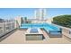 Inviting rooftop deck with a cozy blue lounge seating area and modern fire pit, perfect for entertaining at 777 N Ashley Dr # 915, Tampa, FL 33602