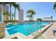 Relax by the rooftop pool surrounded by palm trees and city skyline views at 777 N Ashley Dr # 915, Tampa, FL 33602
