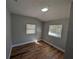 Cozy bedroom featuring two windows and attractive wood-look flooring at 8101 N Alaska St, Tampa, FL 33604