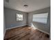 Bright bedroom with hardwood floors, two windows, and neutral paint at 8101 N Alaska St, Tampa, FL 33604