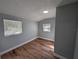 Cozy bedroom featuring two windows and attractive wood-look flooring at 8101 N Alaska St, Tampa, FL 33604