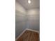 Walk-in closet with installed shelving and attractive wood-look flooring at 8101 N Alaska St, Tampa, FL 33604