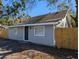 Charming single-story home featuring gray siding, a new wooden fence, and well-maintained landscaping at 8101 N Alaska St, Tampa, FL 33604