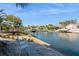 Scenic canal view, with a well-maintained bank and a sunny seating area at 815 Paradise Way, Sarasota, FL 34242