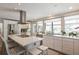 Spacious kitchen with island seating, stainless steel appliances, and modern white cabinets at 815 Paradise Way, Sarasota, FL 34242