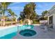 Beautiful pool area with a waterslide, spa, and lush tropical landscaping overlooking the canal at 815 Paradise Way, Sarasota, FL 34242