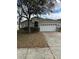 Inviting single-Gathering home featuring a two-car garage and mature landscaping at 8480 Southern Charm Cir, Brooksville, FL 34613