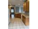 Bright kitchen with tile flooring, wood cabinetry, and modern appliances at 8480 Southern Charm Cir, Brooksville, FL 34613