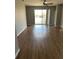 Sun-filled room with updated floors and sliding glass door leading to outdoor space at 8480 Southern Charm Cir, Brooksville, FL 34613