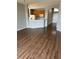 Open-concept living room featuring updated flooring and a view of the kitchen at 8480 Southern Charm Cir, Brooksville, FL 34613