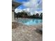 A community pool is surrounded by lounge chairs, perfect for relaxing on a sunny day at 8480 Southern Charm Cir, Brooksville, FL 34613