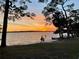 A scenic view of the beach at sunset with silhouettes of people at 9 N Aurora Ave, Clearwater, FL 33765