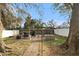 Private backyard featuring a stone paver patio, pergola, and outdoor dining area, ideal for entertaining at 918 W Knollwood St, Tampa, FL 33604