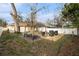 Open backyard featuring a stone paver patio with a pergola and seating for outdoor dining and entertaining at 918 W Knollwood St, Tampa, FL 33604