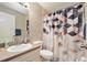 Traditional bathroom with a shower-tub combination, sink vanity, toilet, and decorative shower curtain at 918 W Knollwood St, Tampa, FL 33604