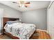 Comfortable bedroom featuring wood floors, a ceiling fan, a closet, and a cozy bed with a stylish comforter at 918 W Knollwood St, Tampa, FL 33604