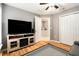 Bedroom with large television, hardwood floors, and ceiling fan at 918 W Knollwood St, Tampa, FL 33604