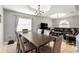 Dining area and living room featuring tile flooring, a modern table, and natural light at 918 W Knollwood St, Tampa, FL 33604