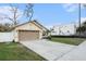 A cozy, single-story home with a lush green lawn and convenient two-car garage at 918 W Knollwood St, Tampa, FL 33604