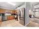 An eat-in kitchen with stainless steel appliances, light wood cabinets and tile flooring at 918 W Knollwood St, Tampa, FL 33604
