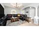 Spacious living room featuring tile floors, a large sectional sofa, and neutral paint at 918 W Knollwood St, Tampa, FL 33604