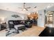 Open floorplan living room with kitchen bar, ceiling fan, and large black leather couch at 918 W Knollwood St, Tampa, FL 33604