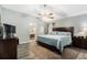 Main bedroom featuring an ensuite bathroom, wood floors, and a ceiling fan at 918 W Knollwood St, Tampa, FL 33604