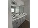 Bathroom with double sink vanity, and tile floor at 921 Night Song St, Valrico, FL 33594