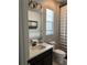 Bathroom showcasing dark vanity with white countertop and modern fixtures at 921 Night Song St, Valrico, FL 33594