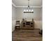 Dining room featuring wood floors, wainscotting, and modern lighting at 921 Night Song St, Valrico, FL 33594