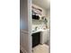 Well-lit laundry room with a sink, black cabinets, a washing machine, dryer, and storage shelf at 921 Night Song St, Valrico, FL 33594