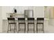 Bright kitchen showcasing white cabinets, stainless steel appliances, and a breakfast bar with seating at 9320 Bonita Mar Dr, Parrish, FL 34219