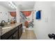 Bathroom featuring double sinks, granite counters, and a modern patterned shower curtain at 9846 Smarty Jones Dr, Ruskin, FL 33573