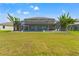 Back exterior view of a screened-in pool and patio with lake views at 9846 Smarty Jones Dr, Ruskin, FL 33573