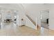 Bright foyer with staircase, neutral tile flooring, and an adjacent dining space at 9846 Smarty Jones Dr, Ruskin, FL 33573