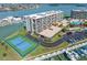 A waterfront condo featuring a tennis court, pool and boat dock at 1 Key Capri # 211W, Treasure Island, FL 33706