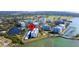 Aerial view of condo community with lake access, boat docks, and lush landscaping at 100 Oakmont Ln # 605, Belleair, FL 33756