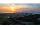 Aerial view of buildings and neighborhood including a golf course at sunset at 100 Oakmont Ln # 605, Belleair, FL 33756
