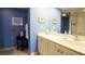 Bathroom featuring a large mirror, spacious countertop, and a shower with a glass door at 100 Oakmont Ln # 605, Belleair, FL 33756