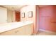 Bright bathroom with a large mirror and a shower, featuring a peach color scheme at 100 Oakmont Ln # 605, Belleair, FL 33756