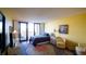 Bedroom featuring balcony access and a comfortable sitting area, with bright colors and a large rug at 100 Oakmont Ln # 605, Belleair, FL 33756