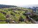 Aerial view of the lush golf course near waterfront, with manicured greens and mature trees around the property at 100 Oakmont Ln # 605, Belleair, FL 33756