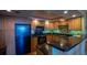 Efficient kitchen with black appliances, granite countertops, and ample cabinet space for storage and preparation at 100 Oakmont Ln # 605, Belleair, FL 33756