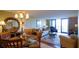 Open-concept layout featuring dining area with a glass table and chairs and a cozy living room at 100 Oakmont Ln # 605, Belleair, FL 33756