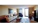 Bright living room featuring a comfortable seating area and sliding glass doors that lead to a balcony at 100 Oakmont Ln # 605, Belleair, FL 33756