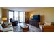 Comfortable living room featuring plush seating, stylish rug, and balcony access with bright light at 100 Oakmont Ln # 605, Belleair, FL 33756