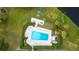 Aerial view of the community pool and recreation area, surrounded by lush landscaping at 100 Oakmont Ln # 605, Belleair, FL 33756