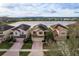 Aerial view of the homes with a lake view in the background at 10262 Newminster Loop, Ruskin, FL 33573