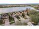 Aerial view of the homes with a lake view in the background at 10262 Newminster Loop, Ruskin, FL 33573